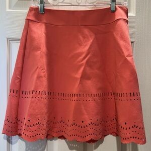 Coral skirt with eyelet design.